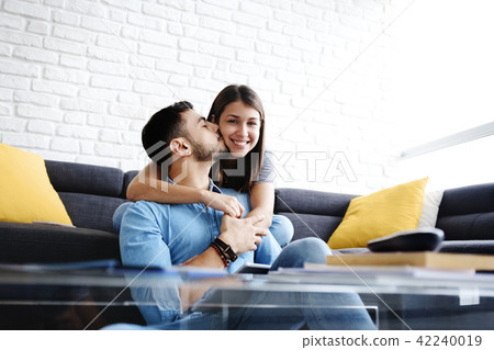 Portrait of Young Couple With Tablet PC Kissing Portrait of Young Couple With Tablet PC Kissing 42240019