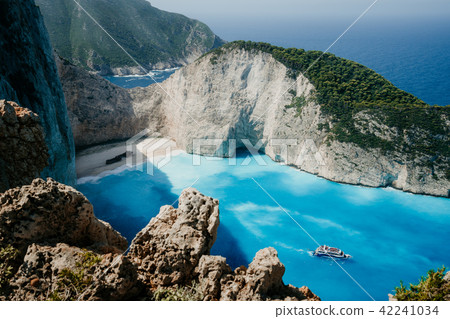 Navagio beach or Shipwreck bay with turquoise water and pebble white beach. Famous landmark location 42241034