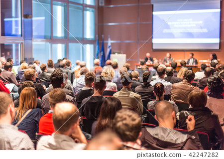 Audience in lecture hall participating at business conference. Audience in lecture hall participating at business conference. 42247282
