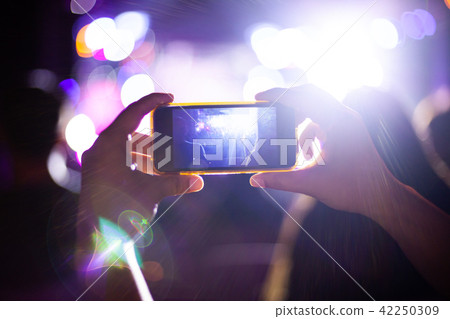 People taking photographs with smart phone 42250309