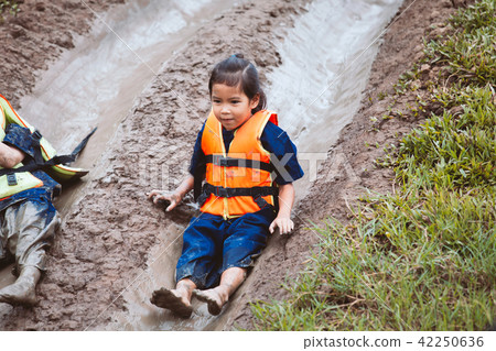 asian child girl having fun to play slider mud asian child girl having fun to play slider mud 42250636