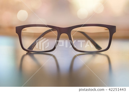 Pastel eye glasses on wood background with bokeh. 42251443