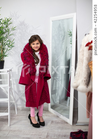 Cute girl playing dress up. 42254958