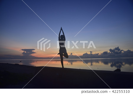Morning glow and yoga pose of Shiraho Beach 42255310