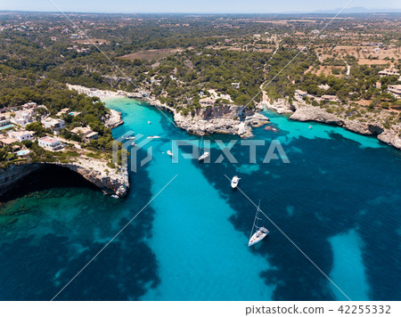Aerial: Cala Llombards beach in Mallorca, Spain 42255332
