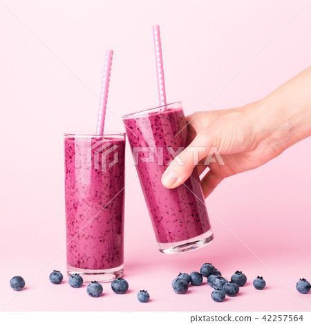 Two glasses of blueberries smoothie. 42257564