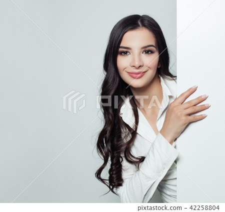 Friendly businesswoman showing empty board  42258804