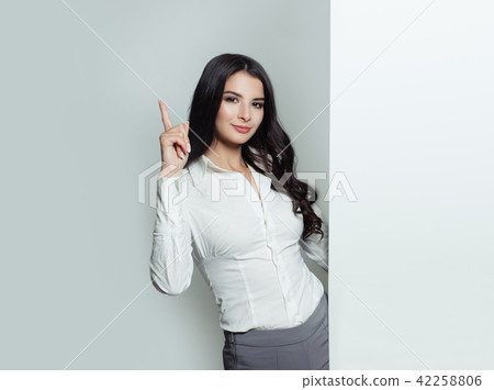 woman pointing up and holding white banner 42258806