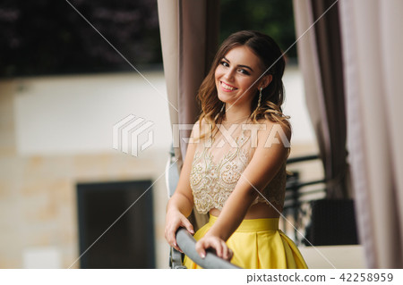 Elegant brunette lady stand on luxury balcony and smile 42258959