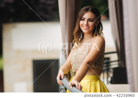 Elegant brunette lady stand on luxury balcony and smile 42258960