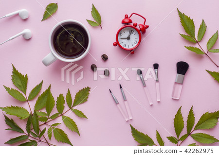 Make-up brushes, a Cup of coffee and clock  42262975