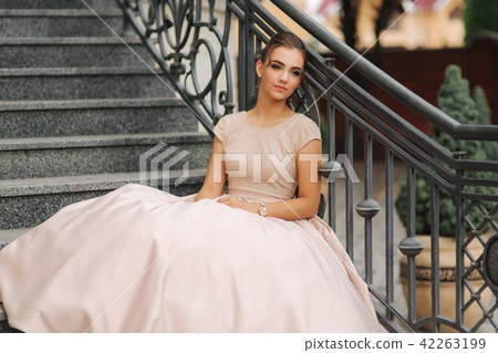 Fashion model sis on stairs by the hotel. Joung girl smile Fashion model sis on stairs by the hotel. Joung girl smile 42263199