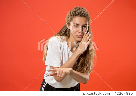 The young woman whispering a secret behind her hand The young woman whispering a secret behind her hand 42264880