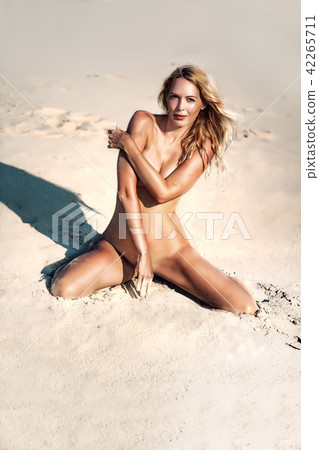 Beautiful girl model on sandy beach of the sea 42265711