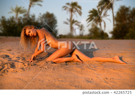 Beautiful girl model on sandy beach of the sea Beautiful girl model on sandy beach of the sea 42265725