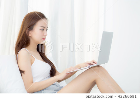 Beautiful young asian woman using laptop. Beautiful young asian woman using laptop. 42266681