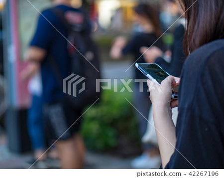Woman using smartphone in the city 42267196