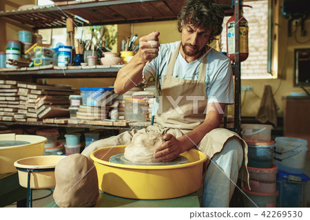 Creating a jar or vase of white clay close-up. Master crock. Creating a jar or vase of white clay close-up. Master crock. 42269530