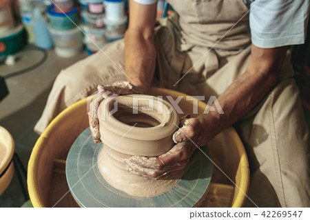 Creating a jar or vase of white clay close-up. Master crock. 42269547