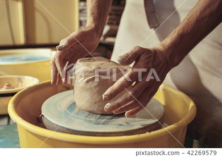 Creating a jar or vase of white clay close-up. Master crock. Creating a jar or vase of white clay close-up. Master crock. 42269579