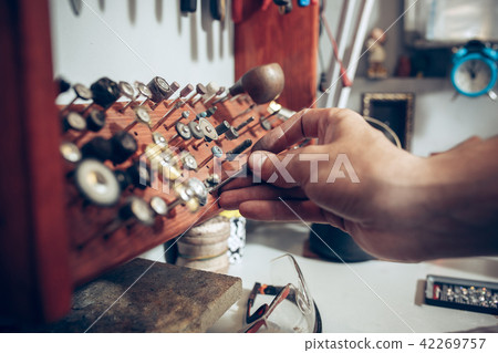 Different goldsmiths tools on the jewelry workplace. Jeweler at work in jewelry. Different goldsmiths tools on the jewelry workplace. Jeweler at work in jewelry. 42269757