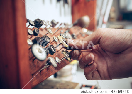 Different goldsmiths tools on the jewelry workplace. Jeweler at work in jewelry. Different goldsmiths tools on the jewelry workplace. Jeweler at work in jewelry. 42269768