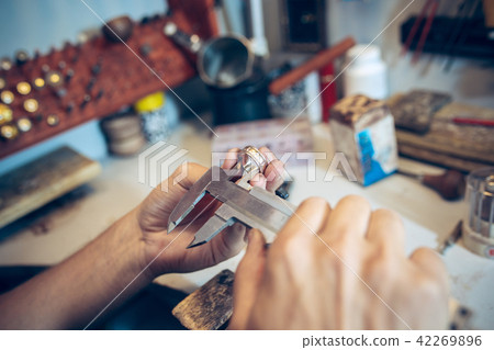 Different goldsmiths tools on the jewelry workplace. Jeweler at work in jewelry. Different goldsmiths tools on the jewelry workplace. Jeweler at work in jewelry. 42269896