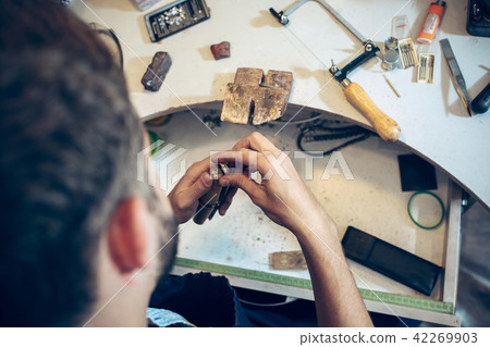 Different goldsmiths tools on the jewelry workplace. Jeweler at work in jewelry. Different goldsmiths tools on the jewelry workplace. Jeweler at work in jewelry. 42269903