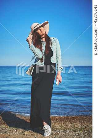 Redhead girl wearing black dress and jeans jacket Redhead girl wearing black dress and jeans jacket 42270143