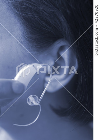 Deaf woman hearing aid ear 42270920