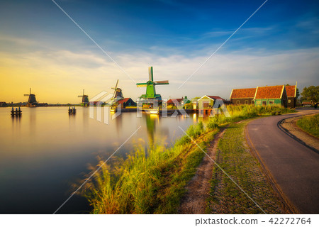 Sunset above farm houses and windmills of Zaanse Schans in the Netherlands Sunset above farm houses and windmills of Zaanse Schans in the Netherlands 42272764