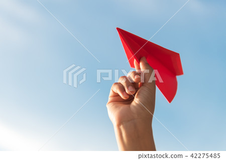 Woman Hand holding red paper rocket 42275485