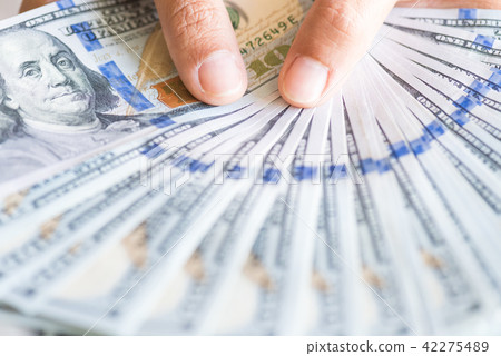 Close up woman hands holding us dollar bills. 42275489