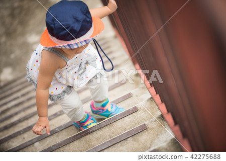 Happy little cute girl walking up the stairs. Happy little cute girl walking up the stairs. 42275688