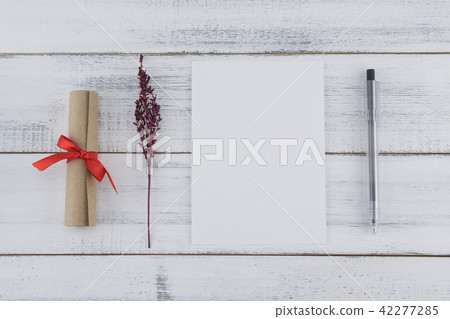 Blank white card, black pen and brown scroll 42277285