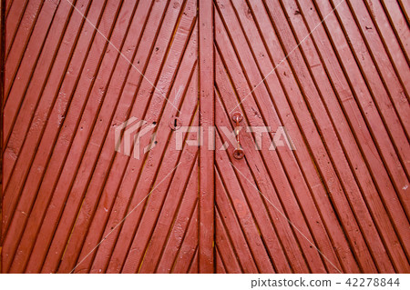 Old burgundy wooden door with handle and keyhole Old burgundy wooden door with handle and keyhole 42278844