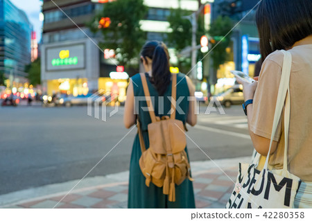 Woman using smartphone in the city Woman using smartphone in the city 42280358