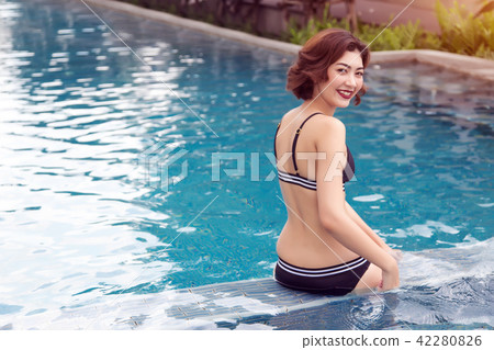 happy asian lady smiling to camera with bikini 42280826