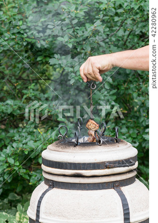 meat skewer coming out of tandir clay oven meat skewer coming out of tandir clay oven 42280962