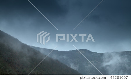Dark mountains with fog and clouds 42281007