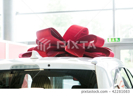 New car with red bow as present concept. New car with red bow as present concept. 42281083