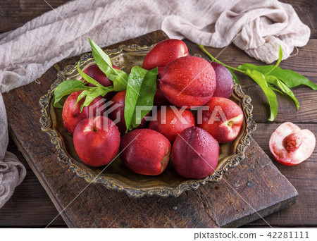 red ripe peaches nectarine in an iron plate red ripe peaches nectarine in an iron plate 42281111