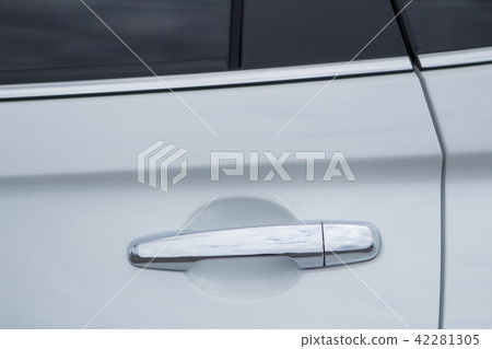 Closeup of white car door handle front view. 42281305