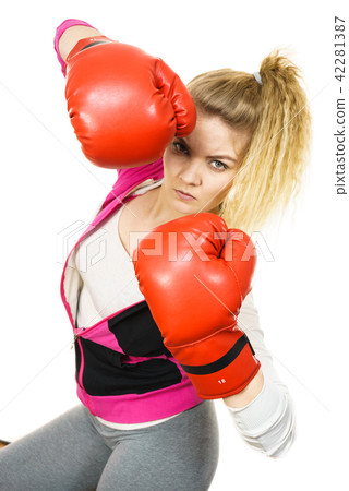 Woman wearing boxing gloves Woman wearing boxing gloves 42281387