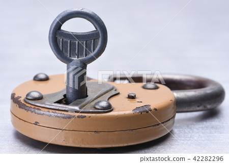 Old rusty padlock with key 42282296