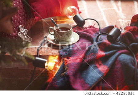 Christmas decoration and tea cup by the window 42285035