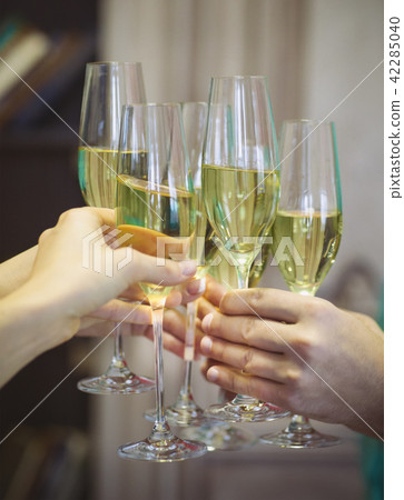 People holding glasses of champagne making a toast 42285040