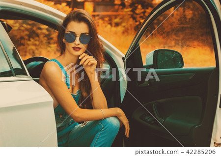 Portrait of young brunette in blue sunglasses Portrait of young brunette in blue sunglasses 42285206