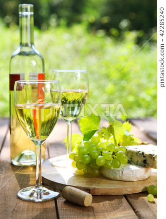 Cheese, grapes and two glasses of the white wine Cheese, grapes and two glasses of the white wine 42285240