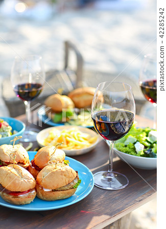 Picnic table with red wine glasses Picnic table with red wine glasses 42285242